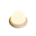 Cream modern bedside remote control night lamp with yellow cave stone light on bedside table