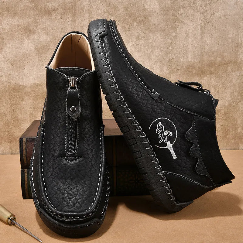 Men's black slip-on loafers with round toe and low heel design showing sewing detail on PU upper