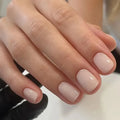 A set of solid light pink false nails (colour MY119) arranged on a card, showcasing their cute style and plastic construction.