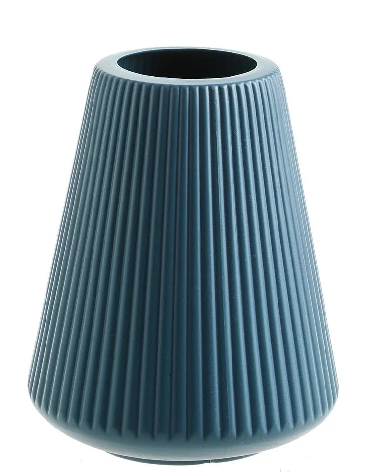 Melamine plastic decorative flower vase in blue colour on desktop