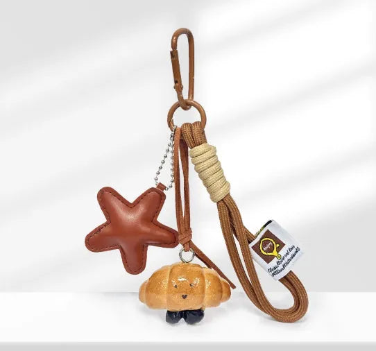 Handmade brown star resin handbag pendant with cartoon soda bread design on a brown strap