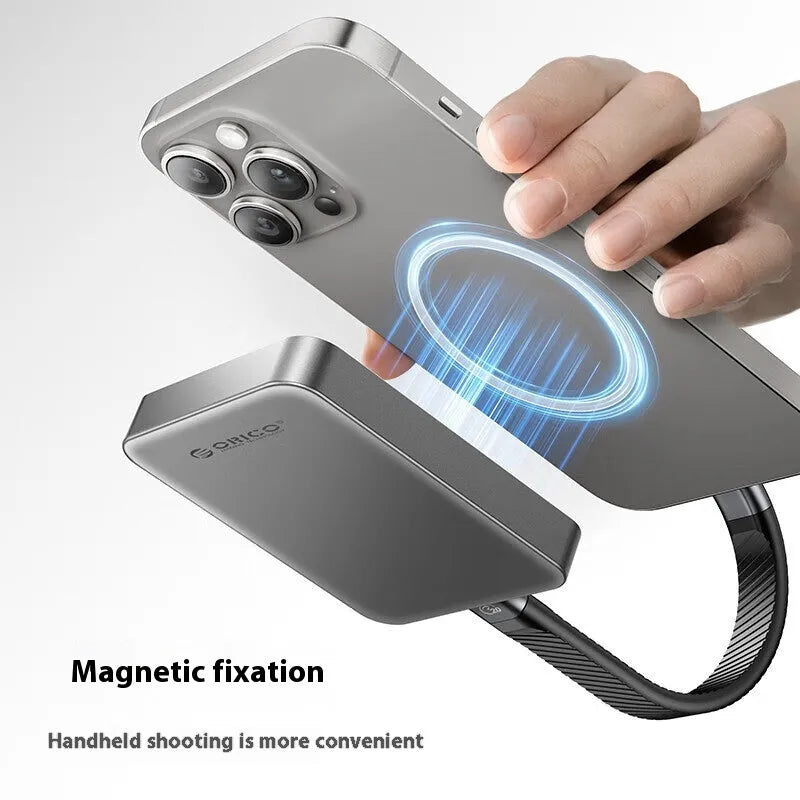 Grey magnetic mobile solid state drive with ultra-thin design next to C to C cable and magnetic suction ring