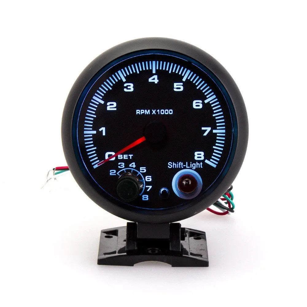 Black automotive tachometer with blue light pointer display showing RPM measurement scale