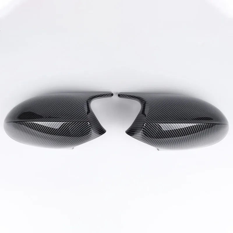 Pair of black ABS plastic rearview mirror housings for BMW 3 Series E90 on a white background.