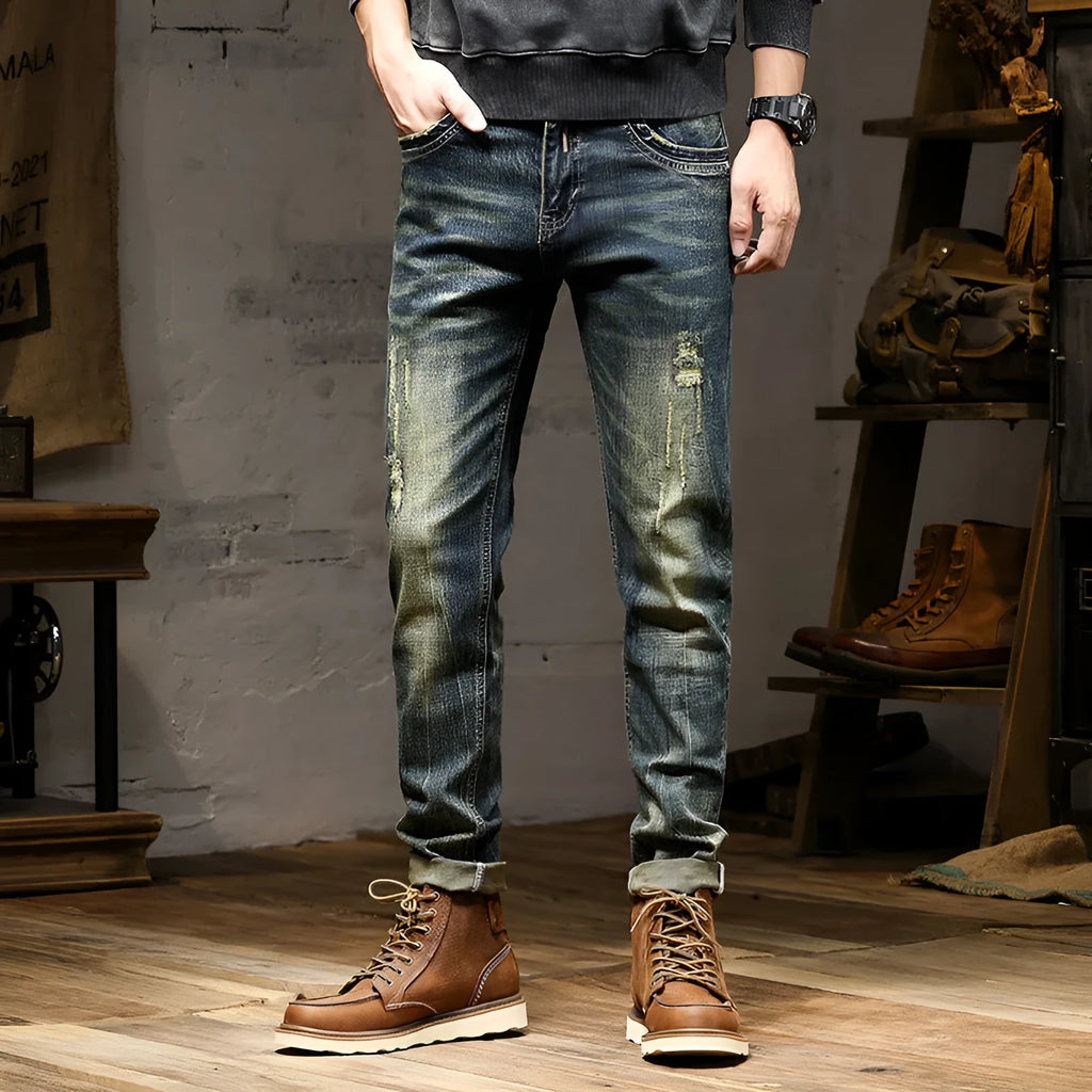 Man wearing skinny fit retro blue jeans with a zip fly, showcasing the casual pencil pants style.