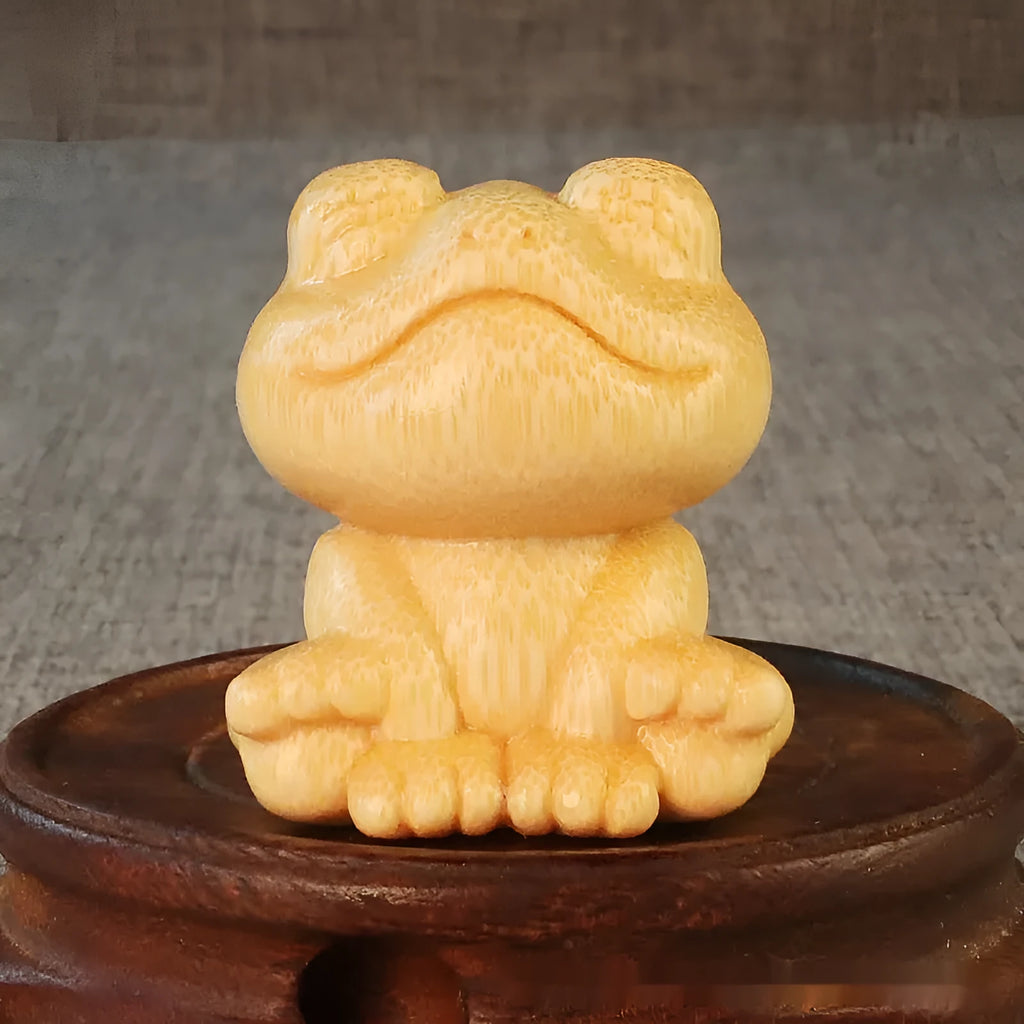 Small smiling frog ornament carved from solid bamboo measuring 5cm in height