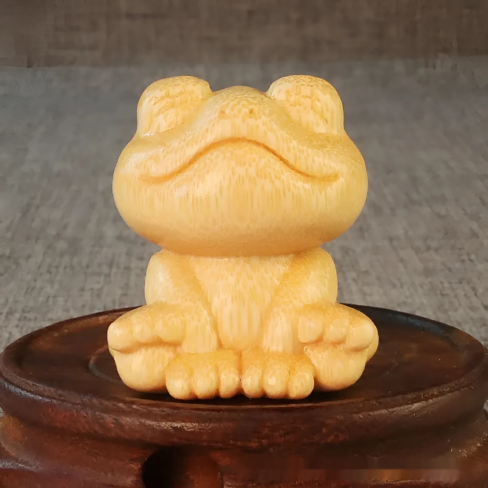 Small smiling frog ornament carved from solid bamboo measuring 5cm in height