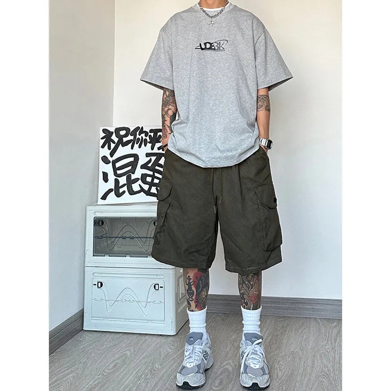 Man wearing loose straight-leg sports shorts in blue, made from polyester fibre.