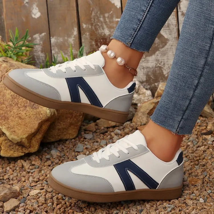 Blue women's flat German training shoes with lace-up front and rubber sole.