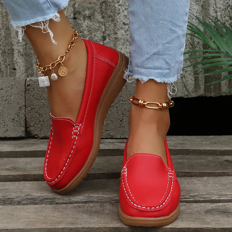 Women's PU leather flats loafers in round toe design with car suture detailing on upper