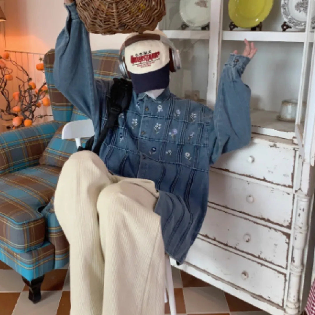 Washed blue denim long sleeve shirt with vintage small floral pleat details on the front.