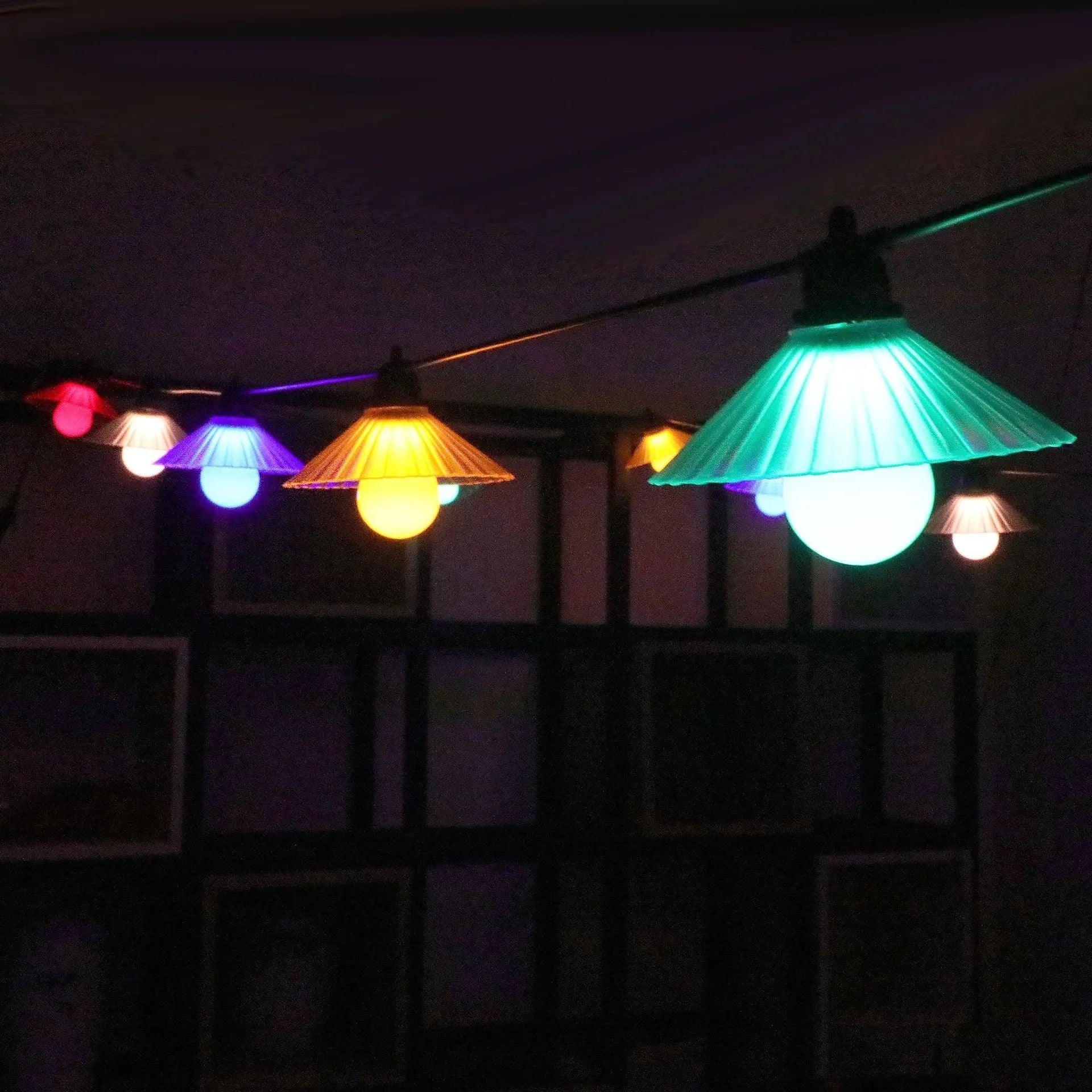 Outdoor LED string lights with flower-shaped bulbs in garden setting showing IP65 waterproof rating
