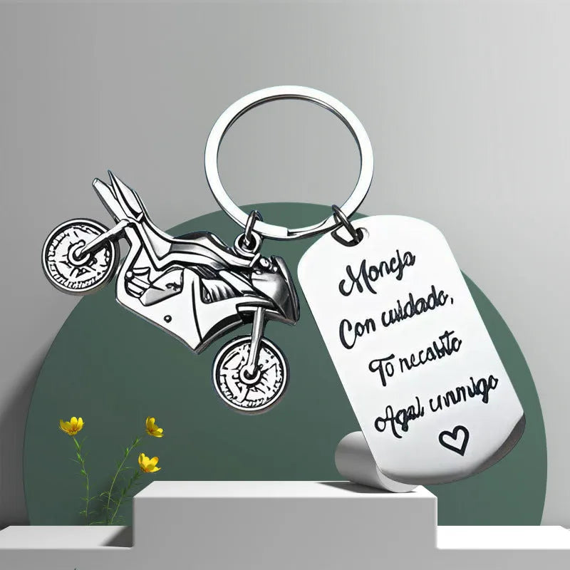 Stainless steel motorcycle keychain on a flannel bag.
