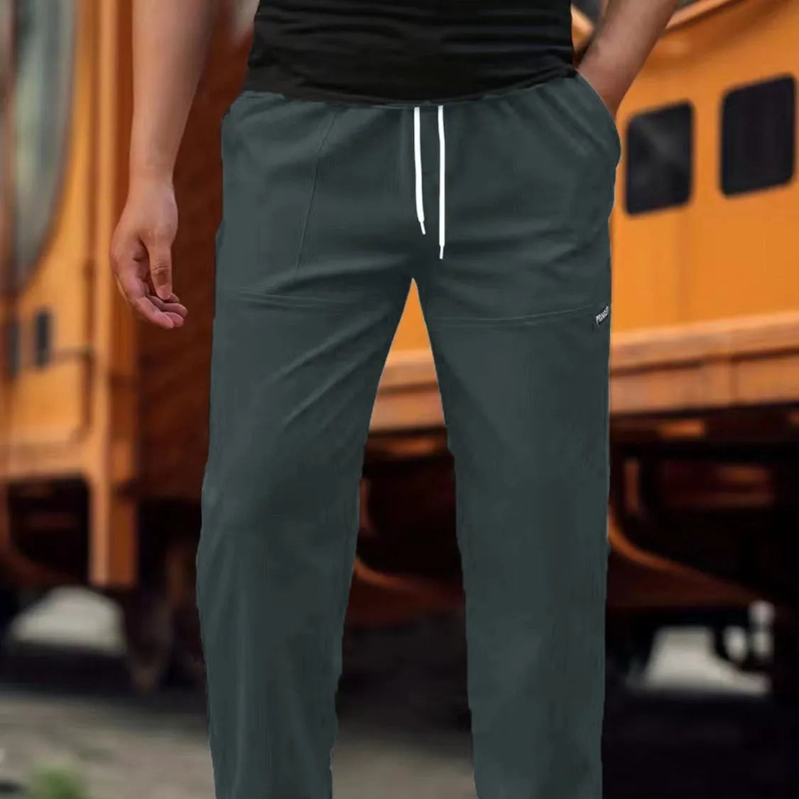 Men's light grey polyester trousers for spring and autumn casual wear, shown in Asian sizing.