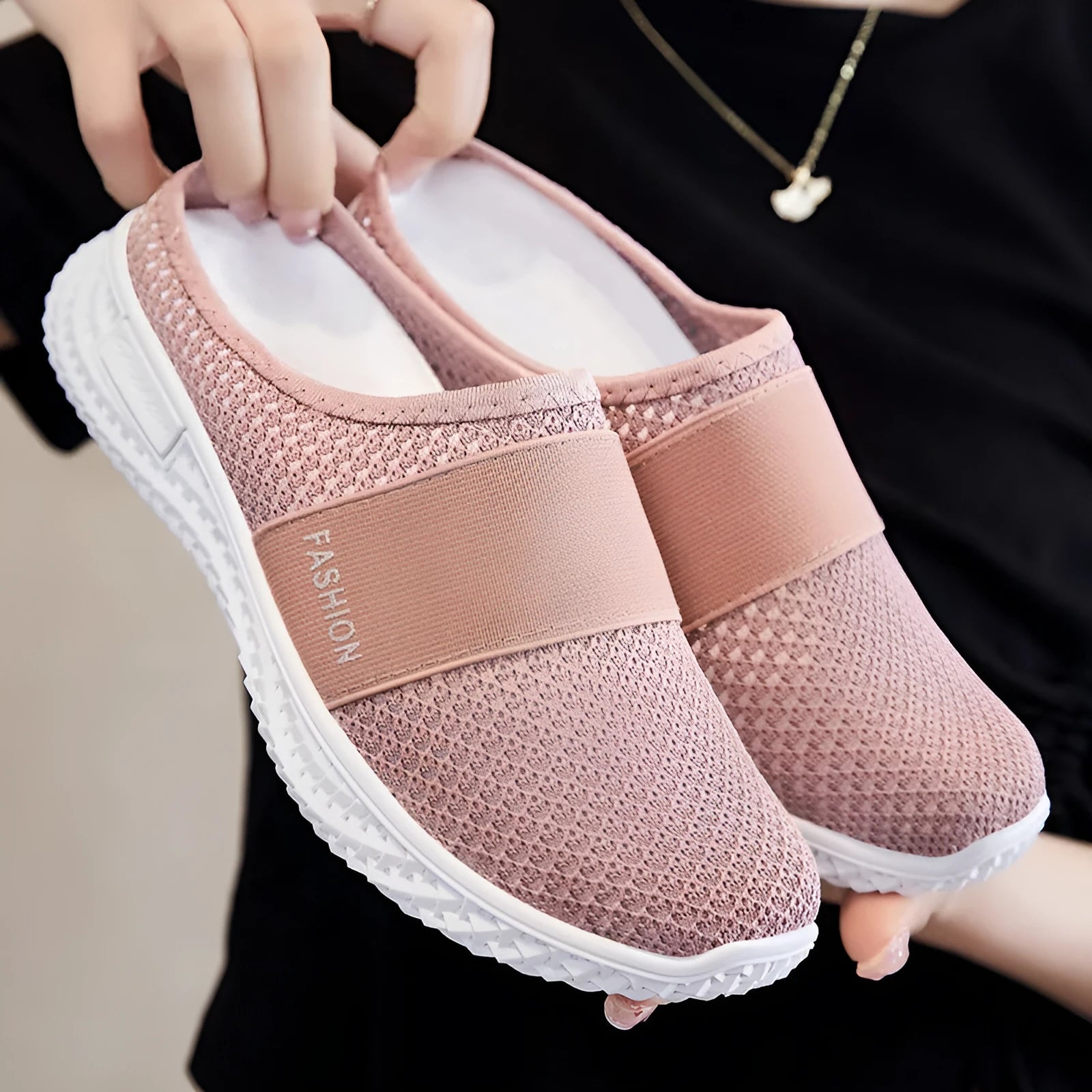 Women's flat-heel casual shoes in mesh material, showing round toe and hollow-out design in black colour.