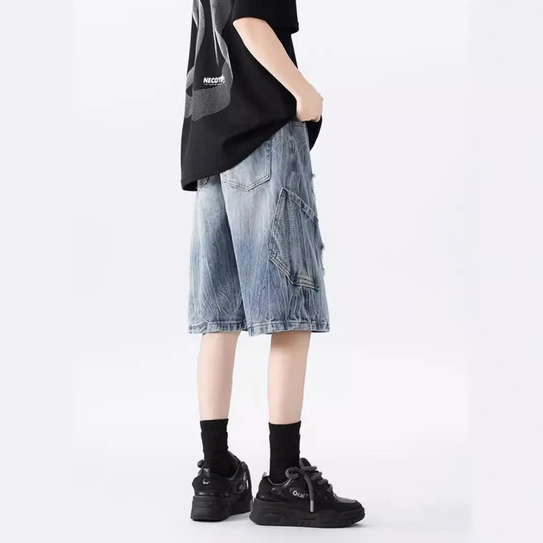 Man's ripped and washed vintage blue denim shorts with a loose, retro fit