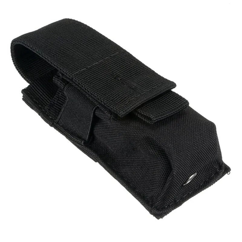Black tactical MOLLE waist bag with elastic cord buckle, shown next to a small flashlight