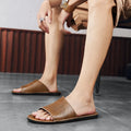 Men's brown and black leather sandals with a rubber sole for casual outdoor wear.