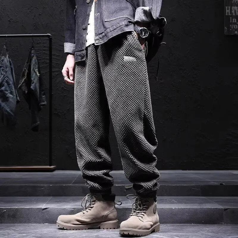 Men's grey ankle-tied casual sweatpants with a light straight leg on a neutral background.
