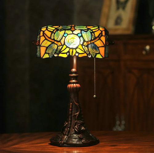 10-inch Tiffany desk lamp with coloured stained glass shade and resin base on a table.