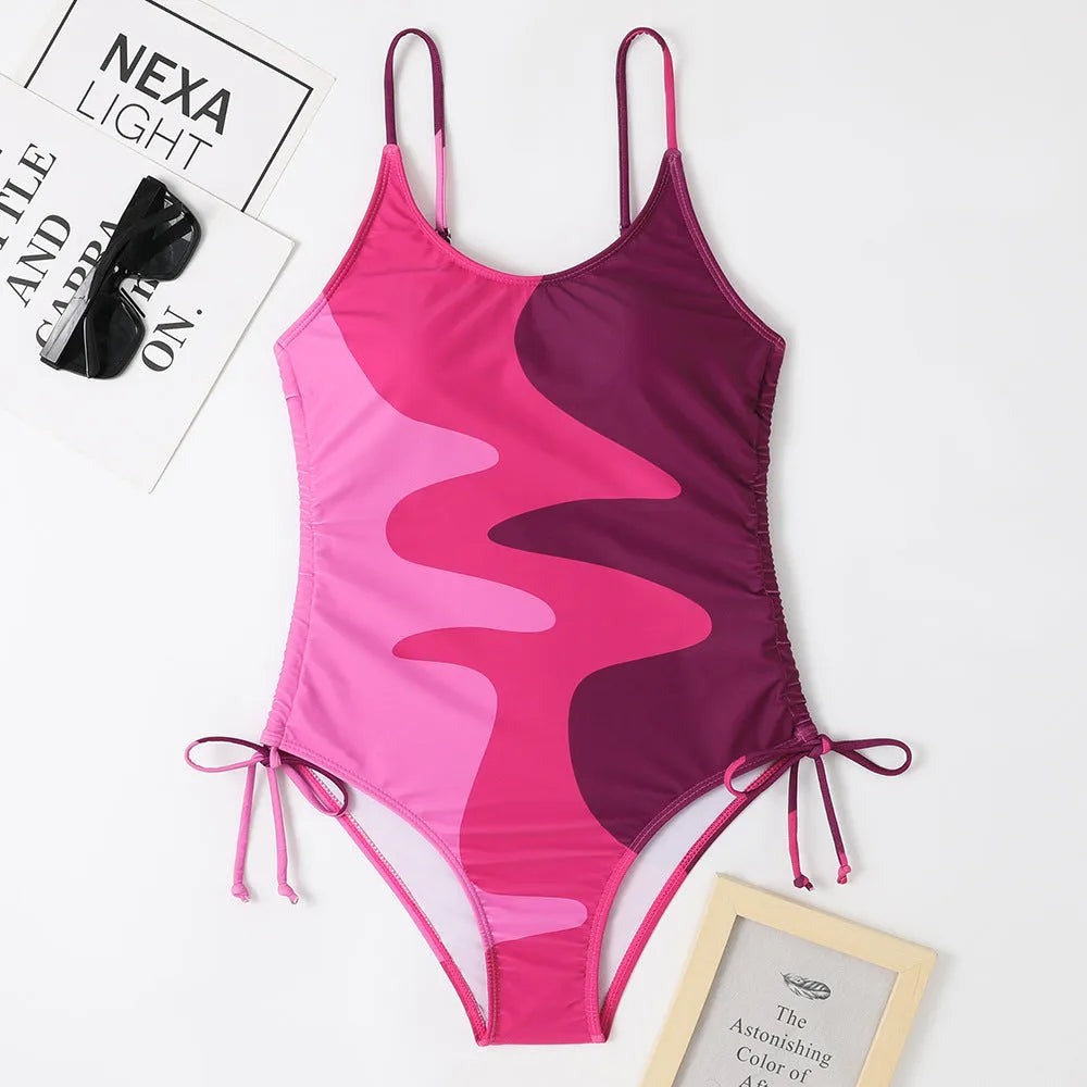 Women's sleeveless backless one-piece swimsuit in blue, shown on a mannequin.