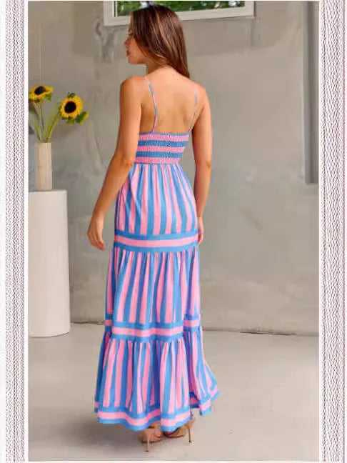 A woman wearing a striped backless suspender summer dress with a square neckline and side pockets.