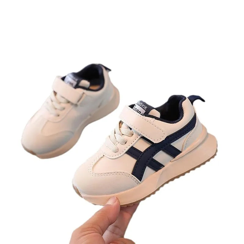 Children's white synthetic leather sneakers with Velcro fastening and a rubber sole