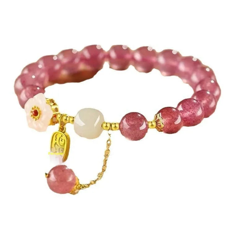 Adjustable strawberry quartz bracelet with Hetian jade peach blossom charm on wrist