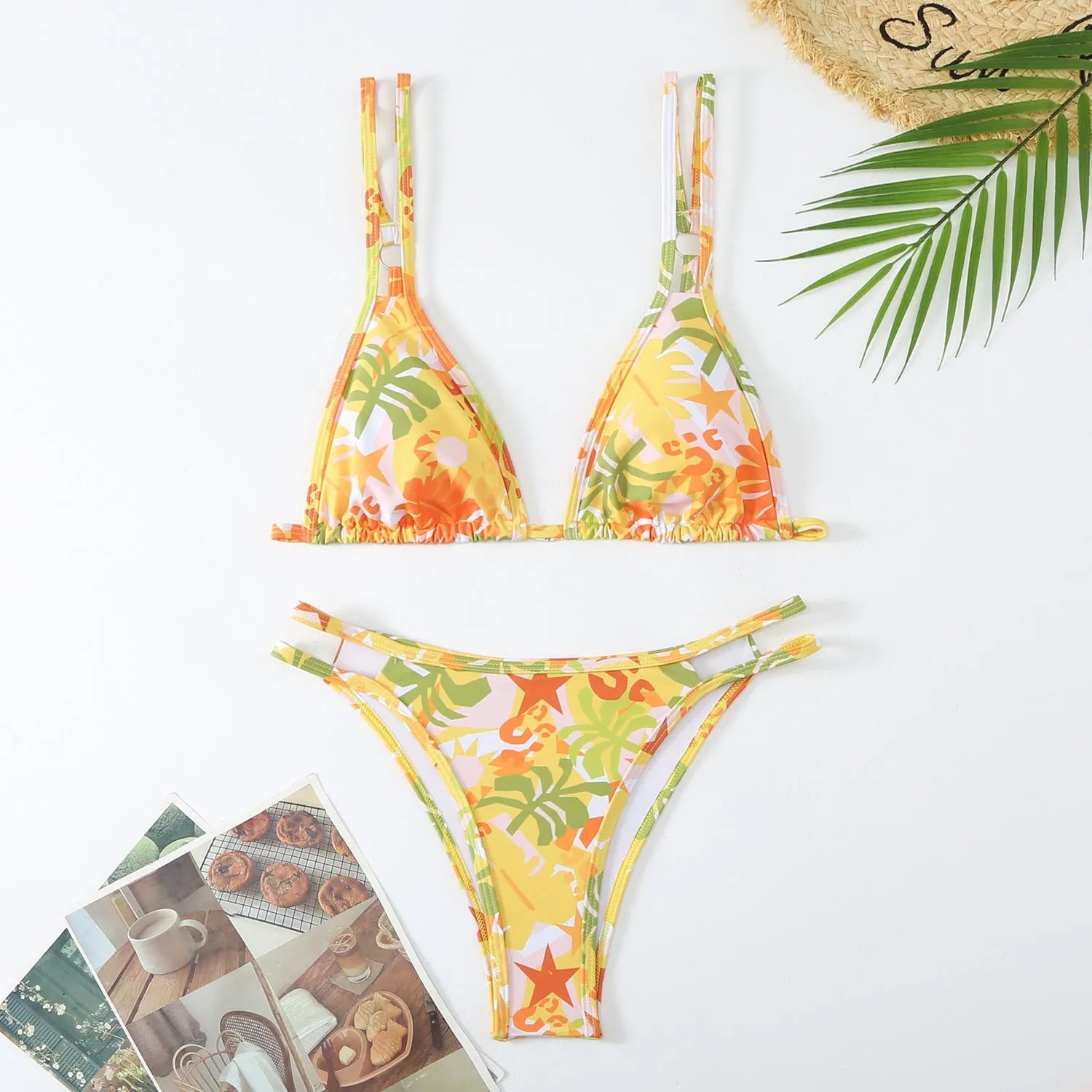 Women's blue halter-style swim briefs with a floral pattern, backless design.