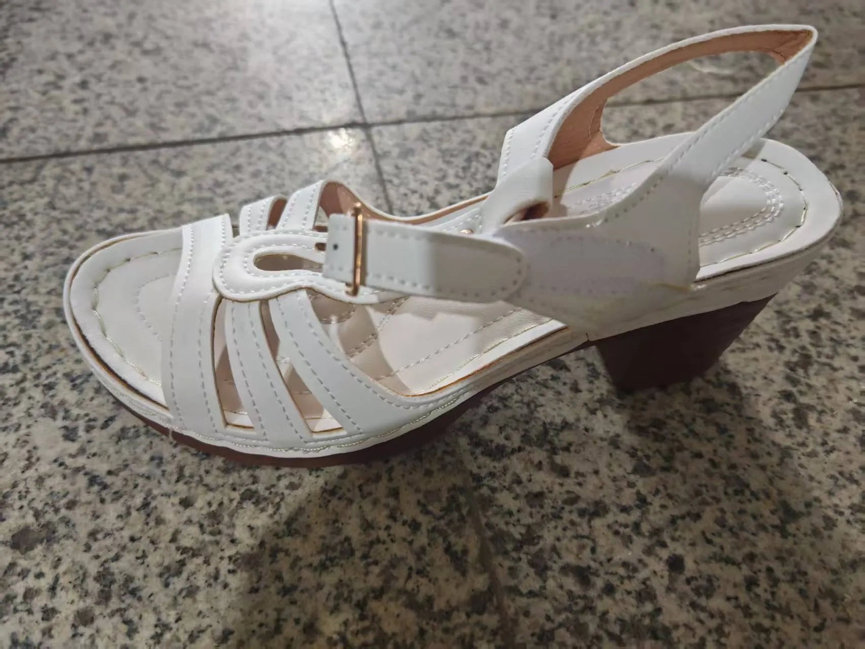 Women's black PU peep toe wedge sandals with a buckle strap on a light background