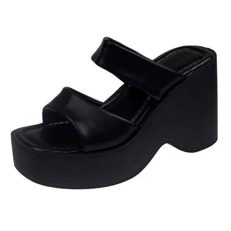 Women's black wedge platform slippers with a square toe on a white background.
