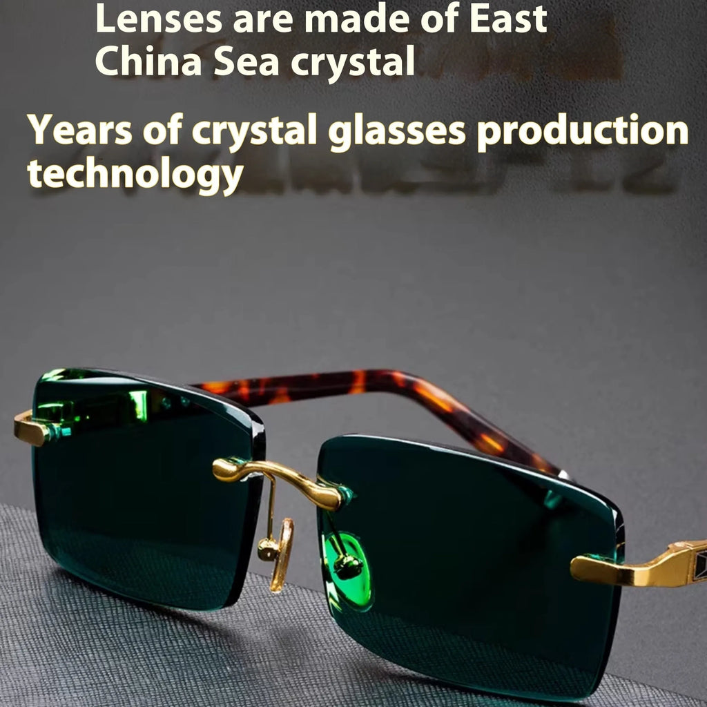 Dark green frameless crystal sunglasses on a case with a lens cloth.