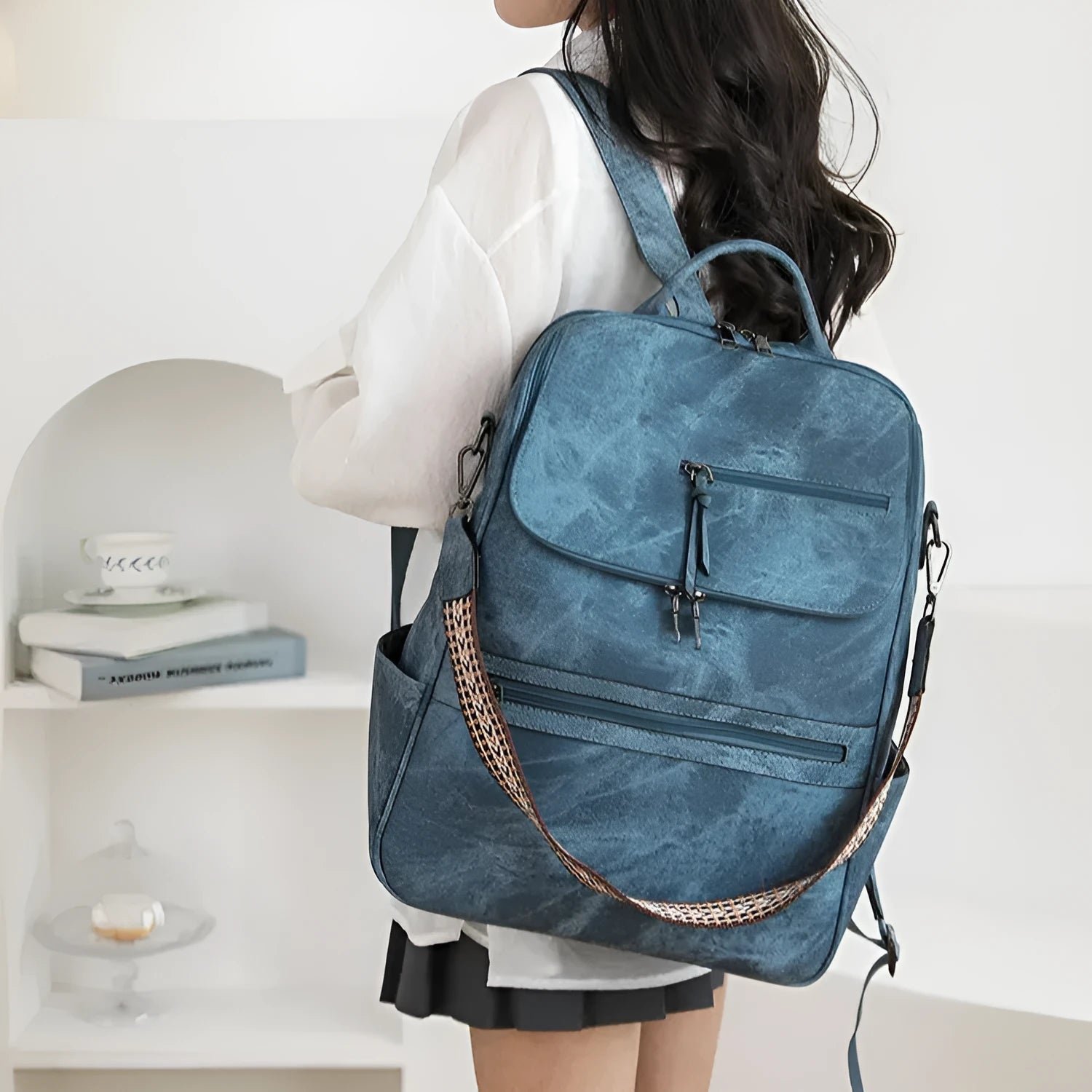 Retro college backpack in PU material with a curved shoulder strap shown in multiple colour options.