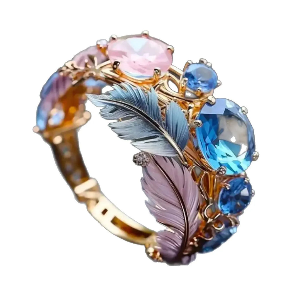 Brass feather ring with embossed geometric design and zircon inlay in gold colour