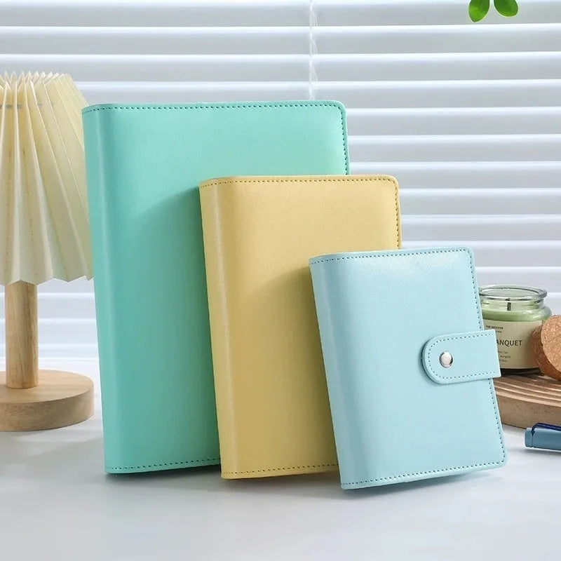 A5 PU leather zippered notebook shell in multiple solid colours including pink, blue, and black.