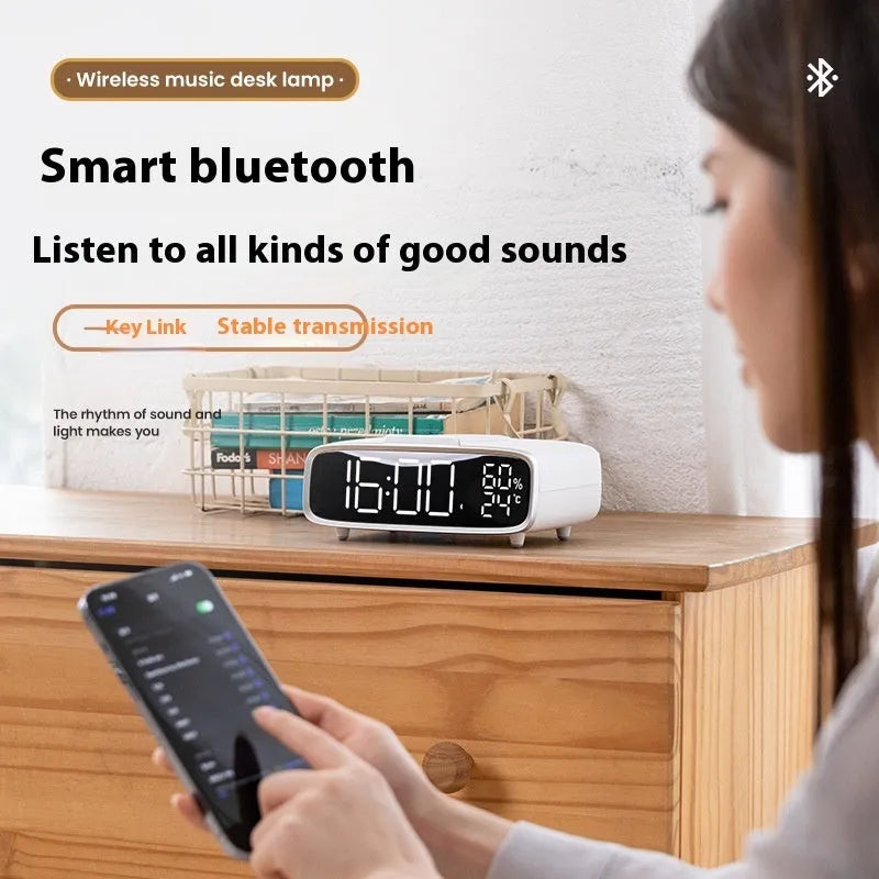 White Bluetooth speaker with integrated wireless charging pad and night light function