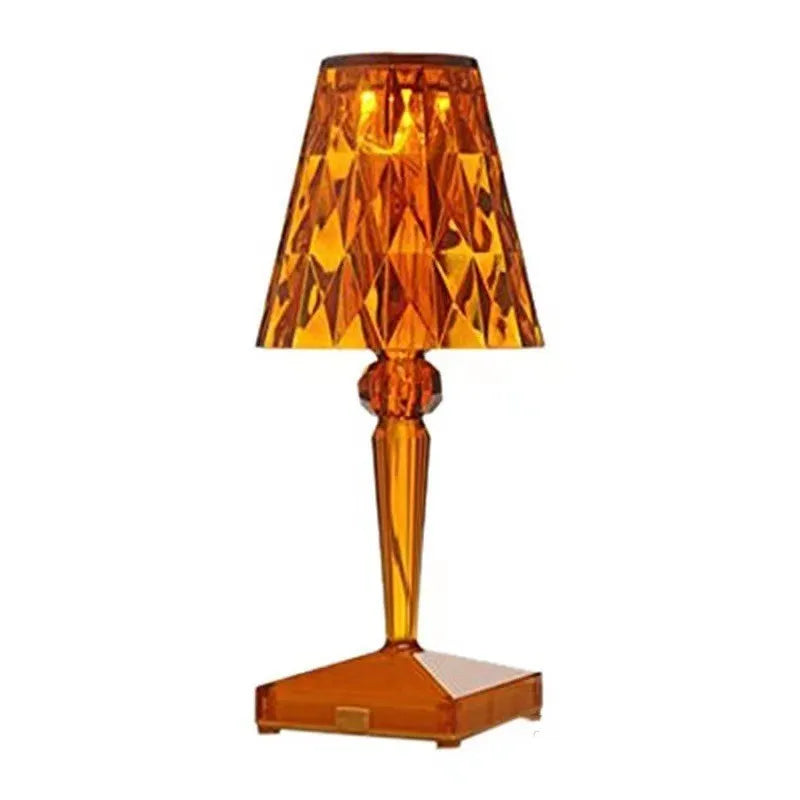 Rose gold portable touch night light with dimmable colours on a table.