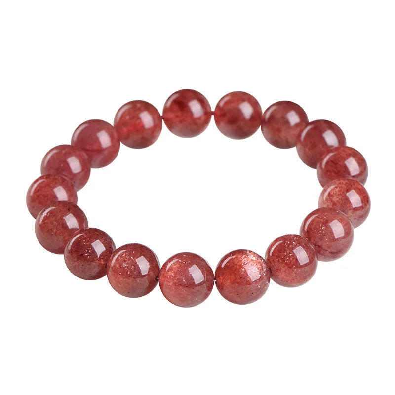 Natural strawberry quartz bracelet with geometry-shaped beads in starlight cherry red colour on a wrist.