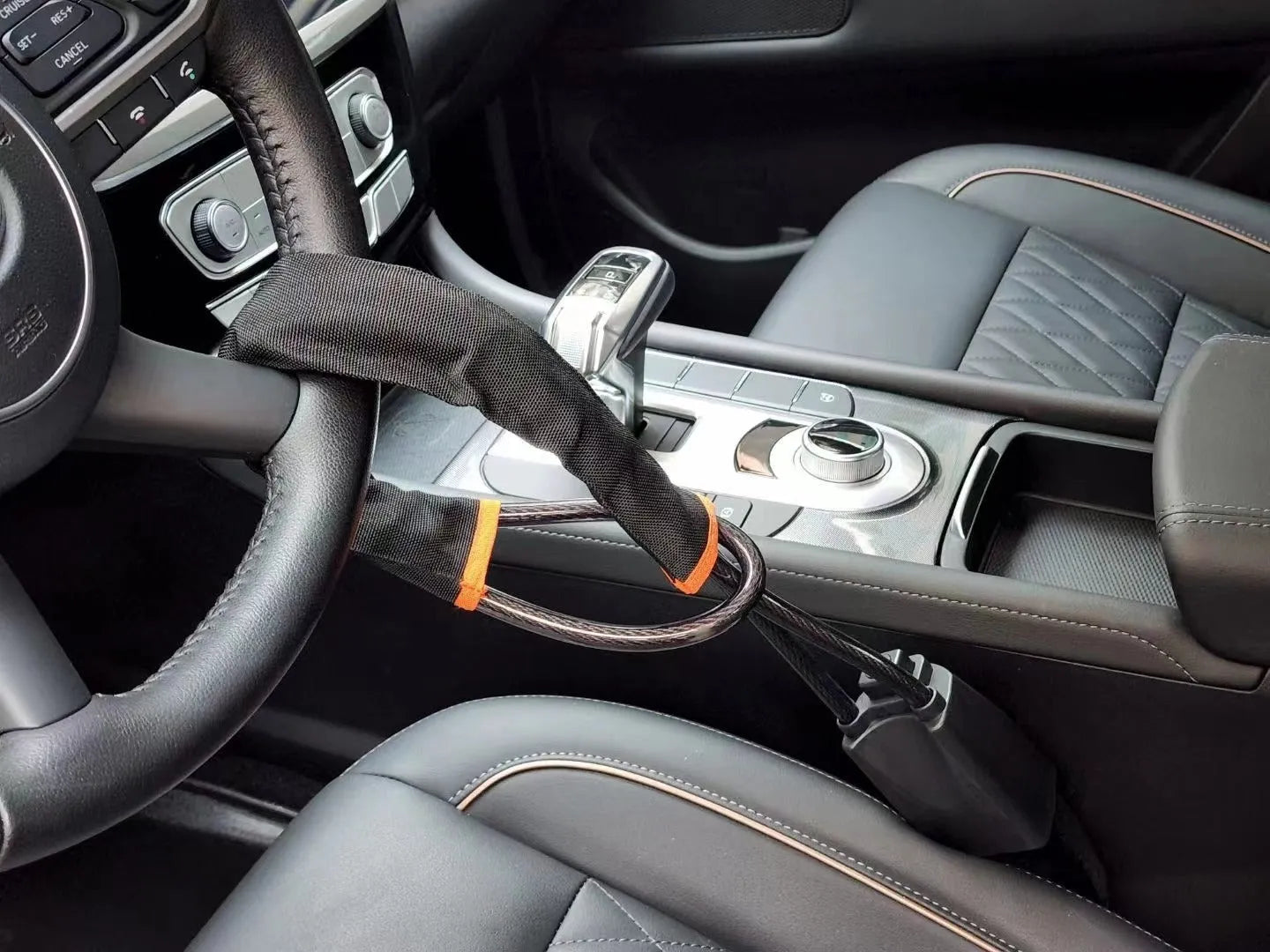 Red iron steering wheel lock with wire rope for a General Motors car.