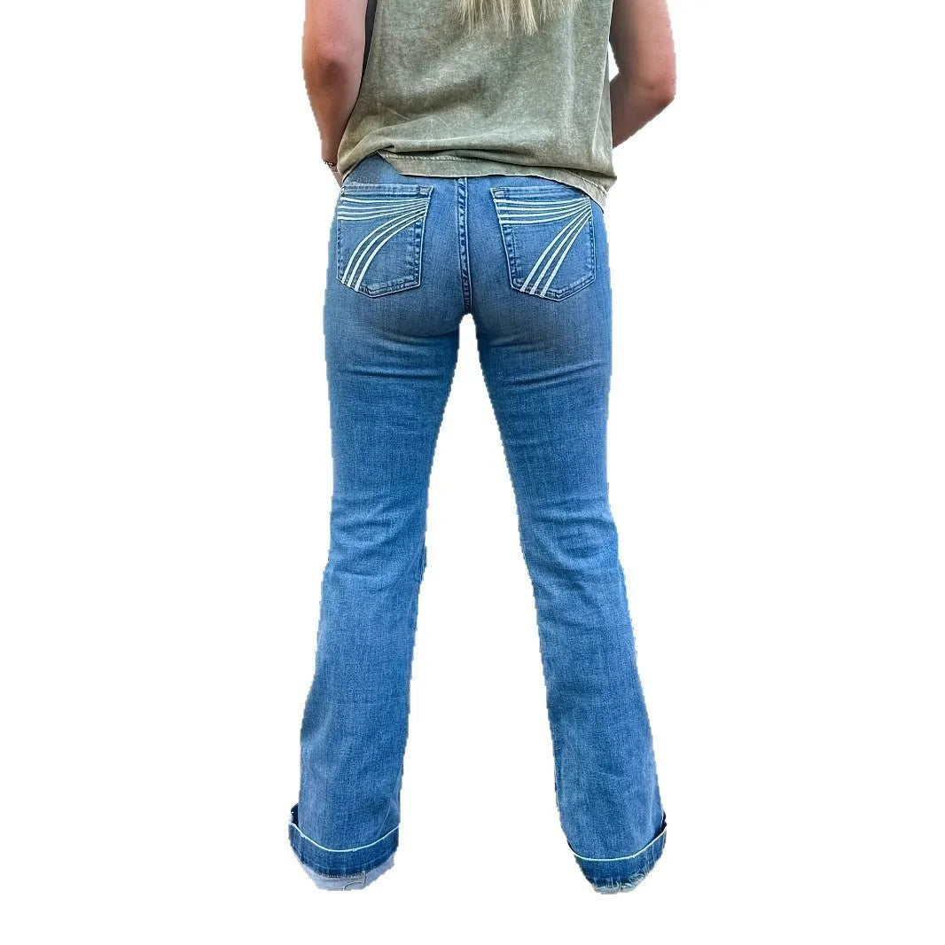 Women's slim fit elastic mid-waist jeans with slight flare and embroidery details on denim