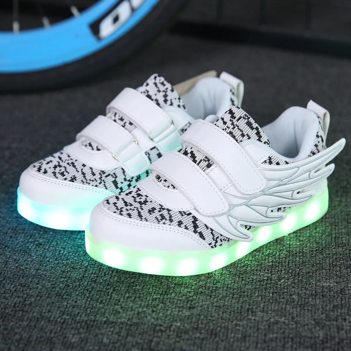 Children's plum red and white LED light-up sneakers with USB charging port and mode switch.