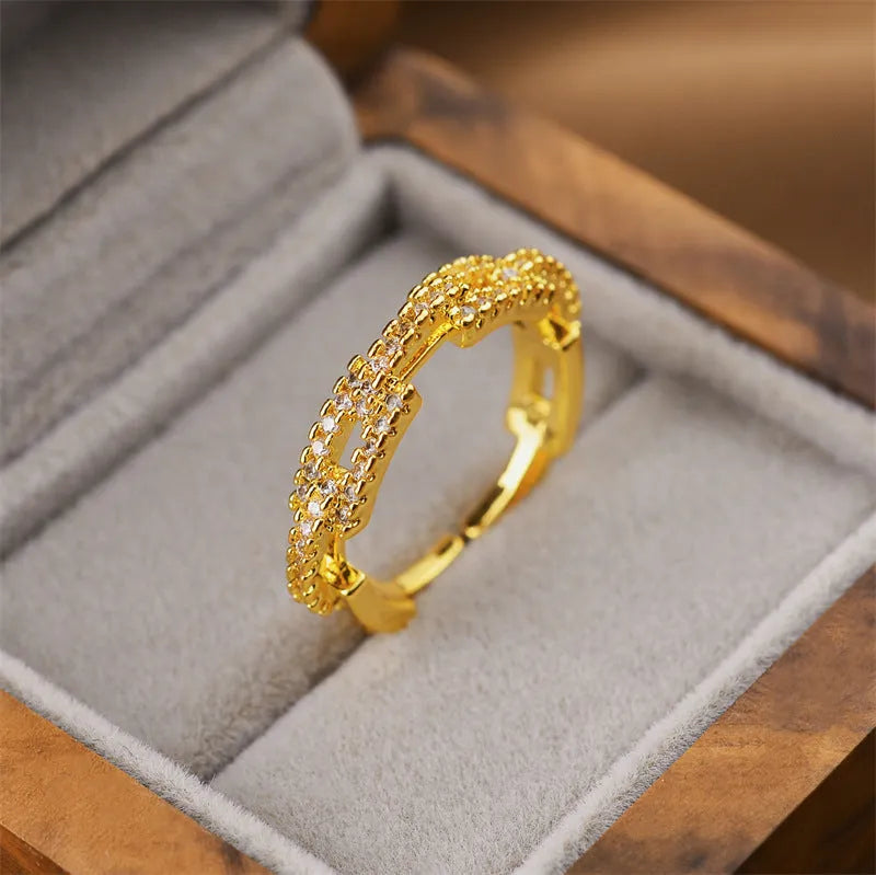 Women's geometric open ring in electroplated gold colour on a copper base.