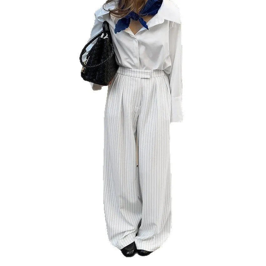 White wide-leg trousers with vertical stripes, loose casual fit, zipper detail, suitable for commuting and office wear