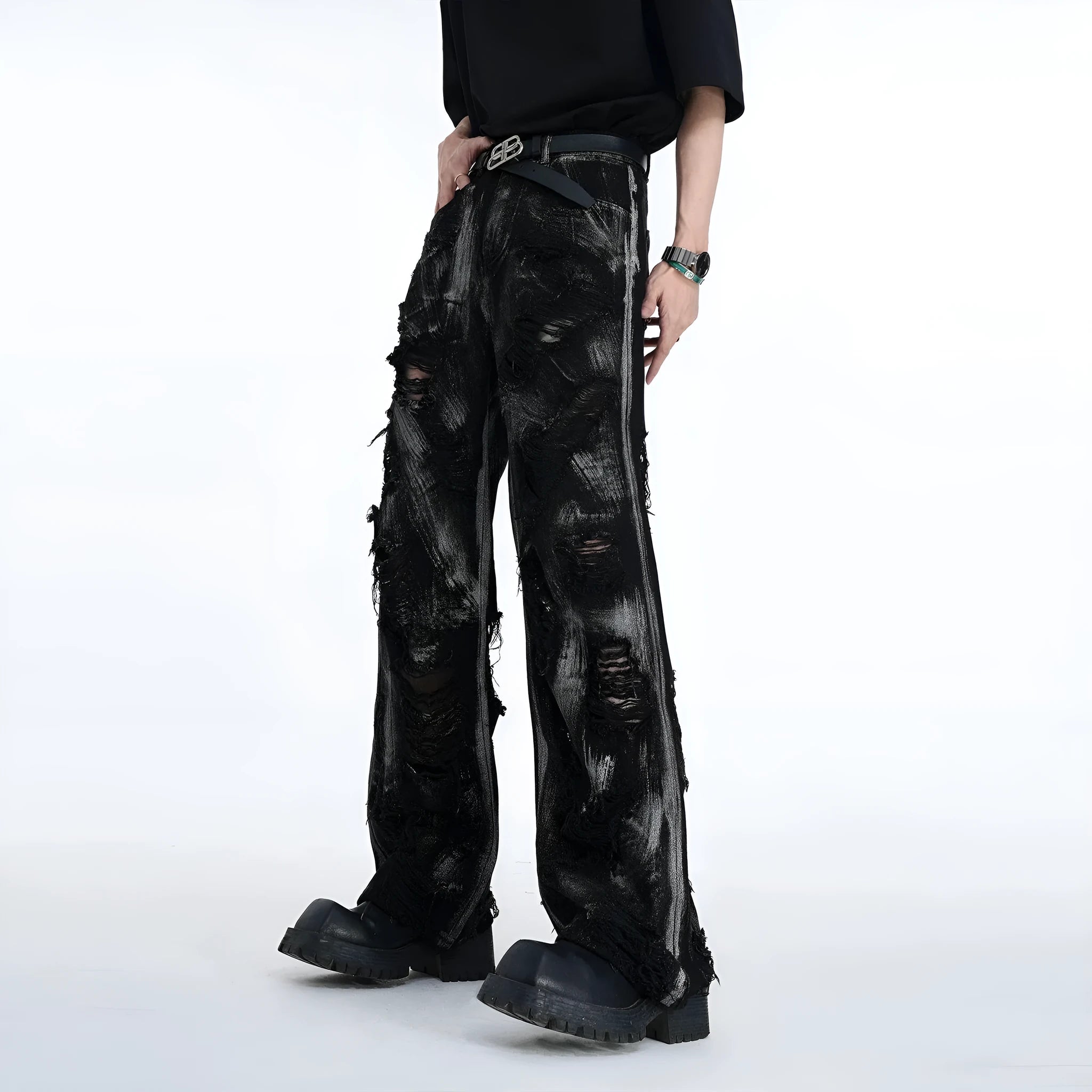 Men's black denim jeans with a heavyweight washed and graffiti-style distressed finish on the legs.