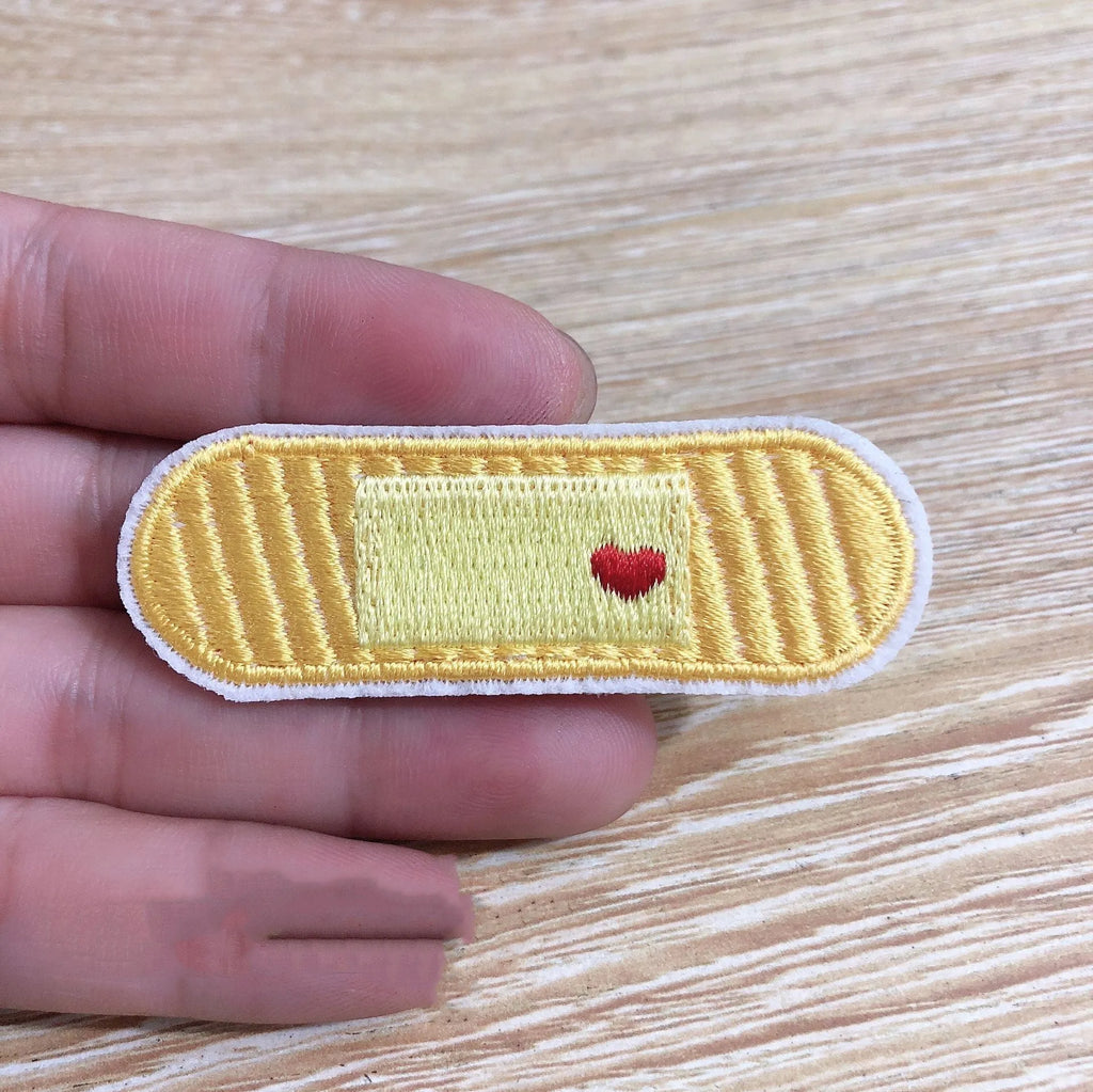 Ten computer embroidered fabric patches with detailed raised designs for clothing decoration
