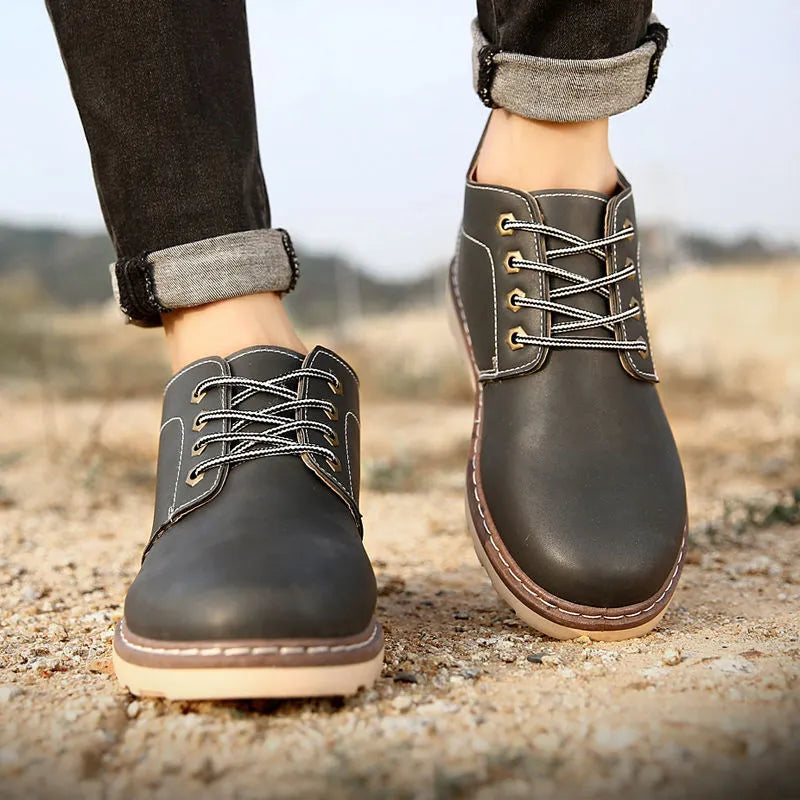 Men's black mid-top leather-style boots with rubber sole showing waterproof non-slip design