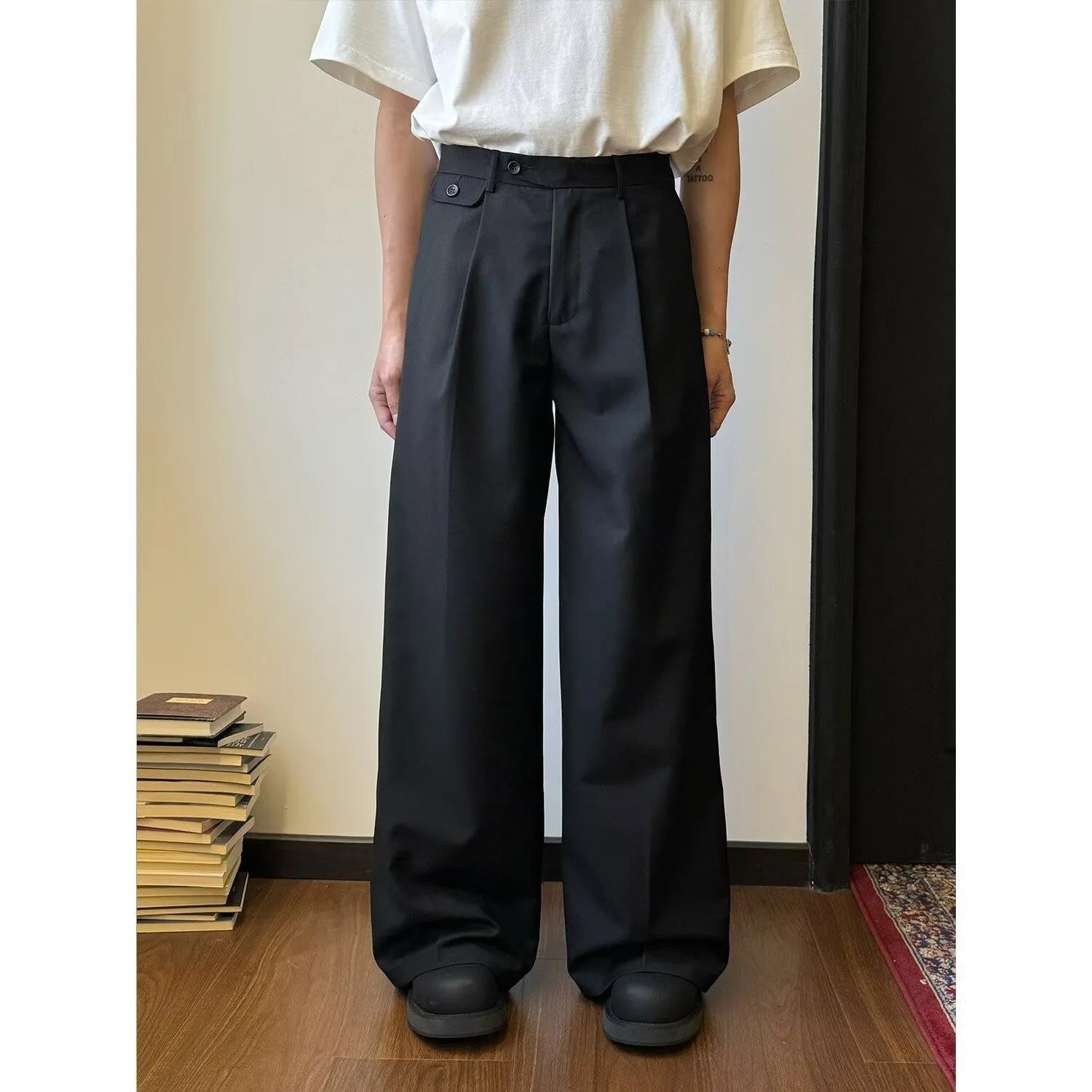 Men's straight-leg casual trousers in polyester blend fabric showing drape and wider cut design