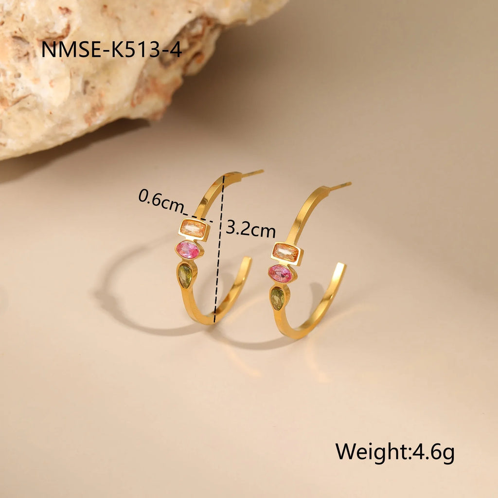 Geometric gold-plated jewellery set showing necklace, ring, and earrings on stainless steel with 18K plating
