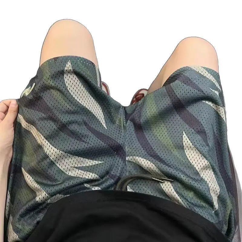 Men's camouflage pattern mesh shorts in straight-leg cut showing cotton-blend fabric texture