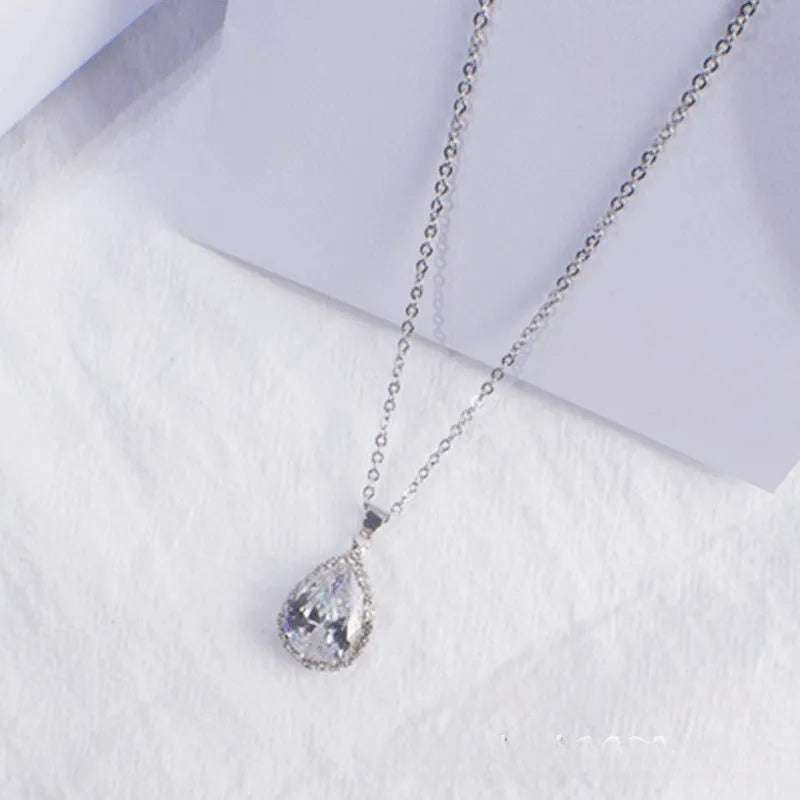 Pink water drop geometric necklace with rose gold electroplating and rhinestone detailing on alloy pendant